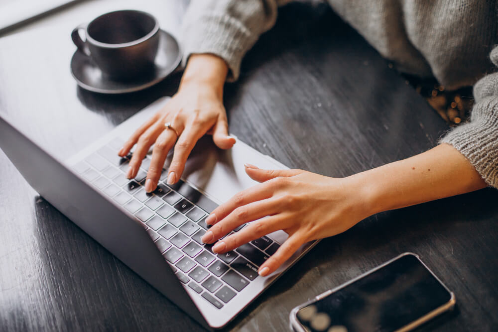 female hands typing computer keyboard