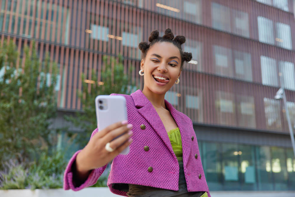 fashionable woman taking a selfie with her smartphone