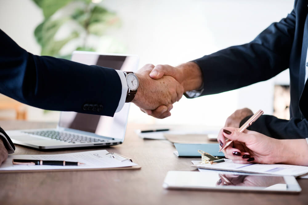 two business people shaking hands together