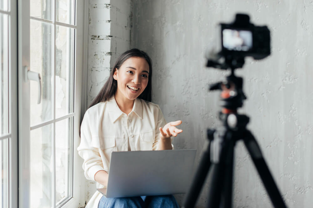 a smiley woman doing vlog indoors